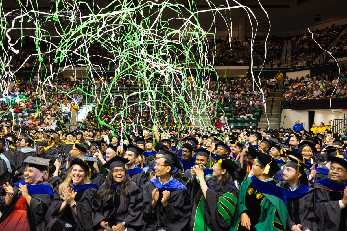 Graduates with confetti overhead